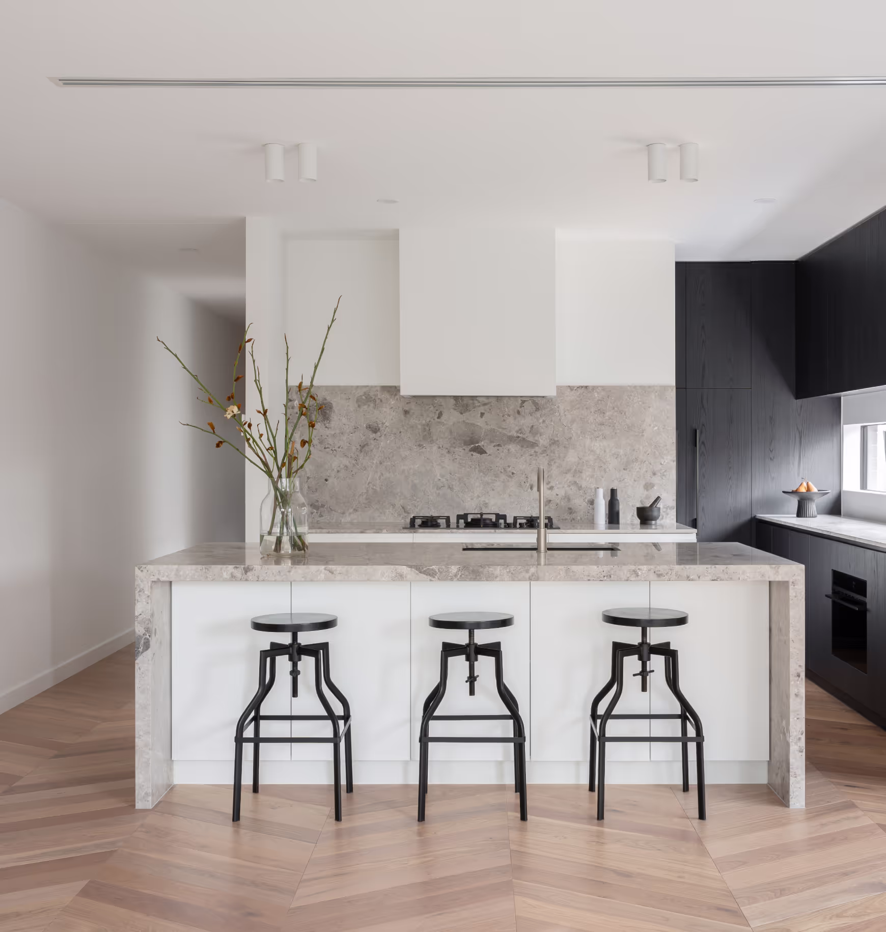 Natural stone island bench and splashback in custom home by Yarraville builder