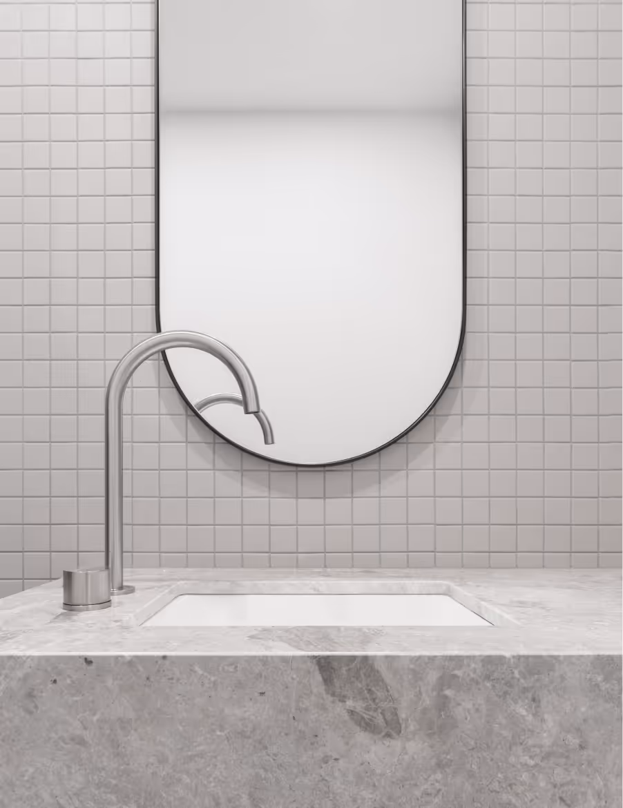Pill mirror and natural stone vanity in bathroom of custom home by Yarraville builder